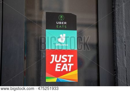 Lyon , Aura France - 04 20 2023 : Deliveroo Just Eat Uber Eats Sign Brand And Sticker Text Logo On D