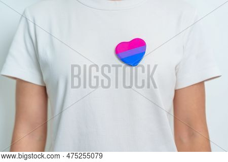 Bisexuality Celebrate Day And Lgbt Pride Month,  Lgbtq+ Or Lgbtqia+ Concept. Hand Holding Purple, Pi