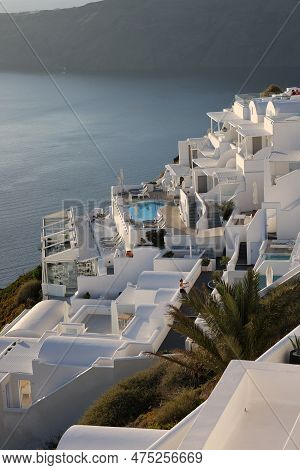 Imerovigli, Santorini, Greece - June 29, 2021: Whitewashed Houses With Terraces And Pools And A Beau