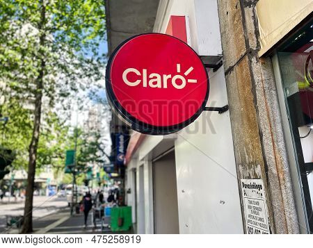 Montevideo, Uruguay - October 31 2022: Round Red Claro Phone Provider Sign Hanging Outside A Retail 
