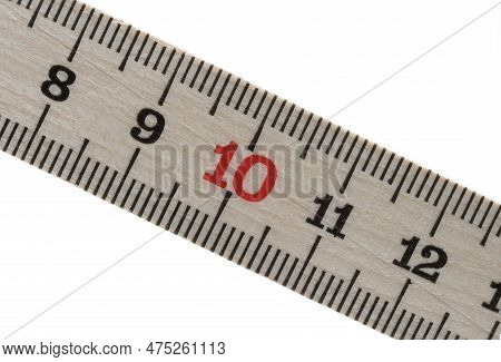 Macro Close-up Partial View Of The Measuring Scale Of A Wooden Meter Rule Folding Rule On A White Ba