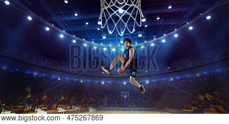 Young Man, Professional Basketball Player In Motion, Jumping With Ball During Match On 3d Stadium Wi