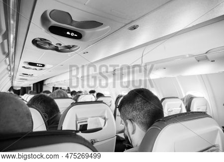 An Interior View Of An Aircraft Cabin Filled With Unrecognizable Passengers, Ready To Go On Their Jo
