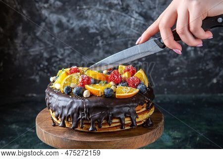 Front View Yummy Chocolate Cake With Fruits Getting Cut By Female On Dark Background Dough Pie Sweet