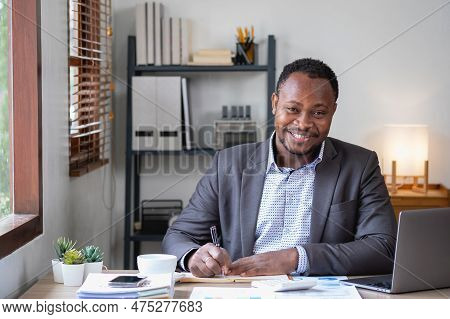 An African American Businessman In A Black Suit Smiling And Showing Joy At The Company's Annual Prof