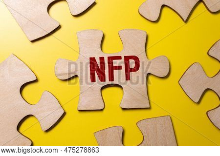 Selective Focus Of Pens, Clock, Money Banknote And Notebook Written With Text Nfp Stands For Nonfarm