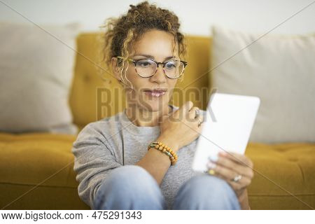 Front View Of Woman Using Tablet At Home In Relaxation Lifestyle Activity. Cute Female People Alone 