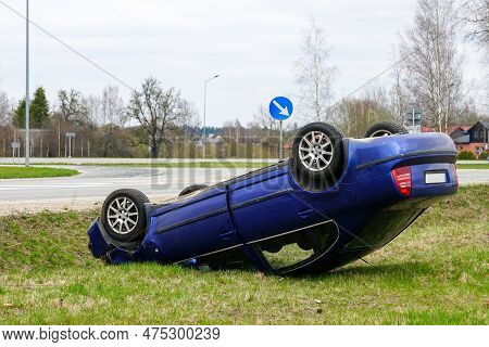 Car Accident Scene, A Passenger Car Left The Road And Overturned With Its Wheels Up, Overturned Car
