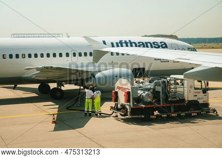 Germany - Jul 6, 2015: A Lufthansa Boeing 737-msn25149 Arrives At An Airport, Surrounded By Workers 