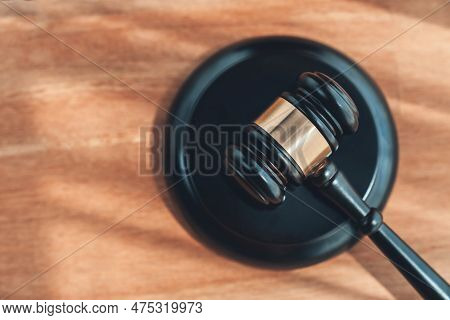 Closeup Top View Black Wooden Gavel Hammer On Wooden Office Desk Background As Justice And Legal Sys