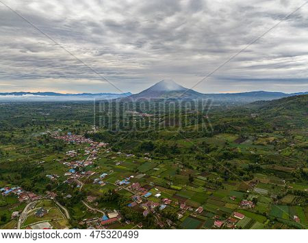 Aerial View Of Berastagi City And Sinabung Volcano At Sunset. Sumatra, Indonesia.
