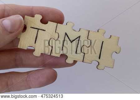 The Acronym Tmi, Which Stands For Too Much Information. The Letters Written On The Puzzles.