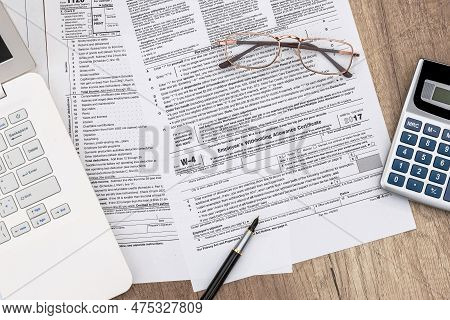 Macro W-4 Form View With Pen, Calculator And Laptop