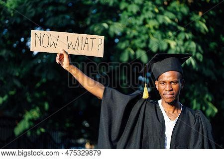 Portrait Closeup Of Young Black Guy Holding In Hand Upraised Cardboard Poster On Street Looking For 