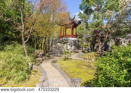 Path Leading To A Small Chinese Temple In The Botanical Garden Of Haren, Netherlands