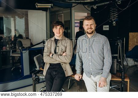 Two College Podcasters Laughing And Having A Good Time In A Studio. Two Happy Young Men Co-hosting A