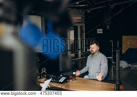 Portrait Of Happy Young Man Working As Radio Host At Radio Station