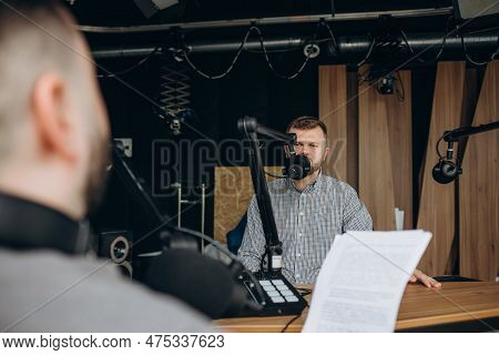 Two College Podcasters Laughing And Having A Good Time In A Studio. Two Happy Young Men Co-hosting A
