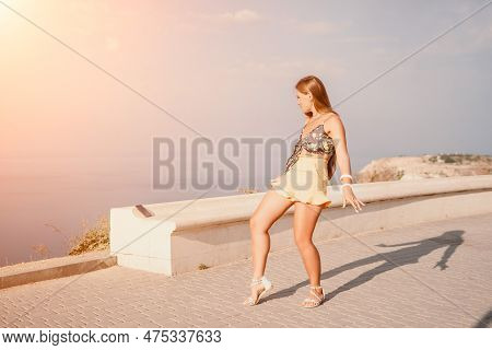 Woman Summer Dance. Silhouette Of A Happy Woman Who Dances, Spins And Raises Her Hands To The Sky. A