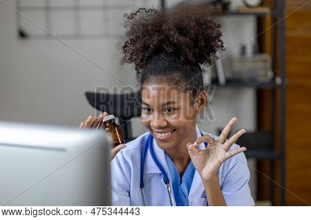 American Female Doctor Is Video Chatting With A Patient, She Is A General Practitioner And Internal
