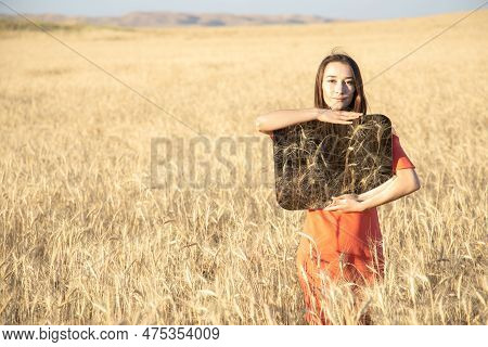 Young Woman In The Wheat Field, Holding Mirror Glass Where Reflected The Dry Grass. Meditation, Ment