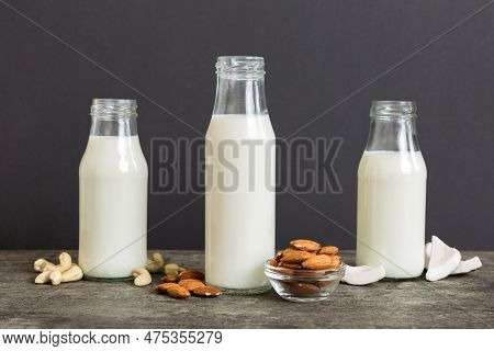 Set Or Collection Of Various Vegan Milk Almond, Coconut, Cashew, On Table Background. Vegan Plant Ba