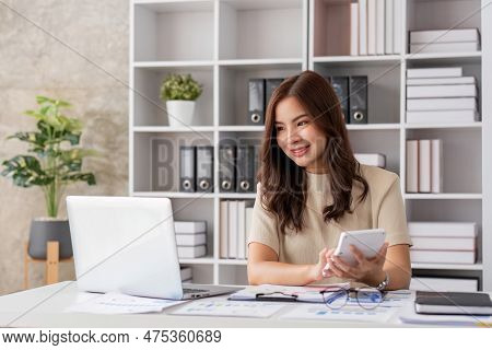 Portrait Of Smiling Beautiful Business Asian Woman Working In Office Use Computer With Copy Space. B