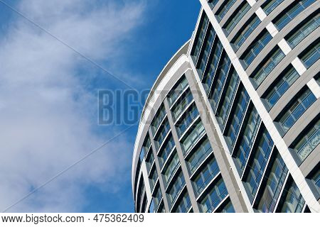 Office Skyscraper High Business Building On Blue Sky Background, Looking Up Tall Glass Windows And S