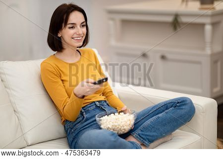 Reaxed Pretty Young Woman Relaxing At Home, Watching Tv