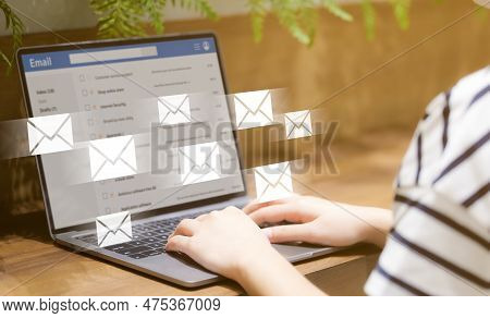 Woman Reading Email And Send Email On Laptop Computer At Public Place. Newsletter And Email Marketin