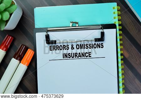 Concept Of Errors & Omissions Insurance Write On Paperwork Isolated On Wooden Table.