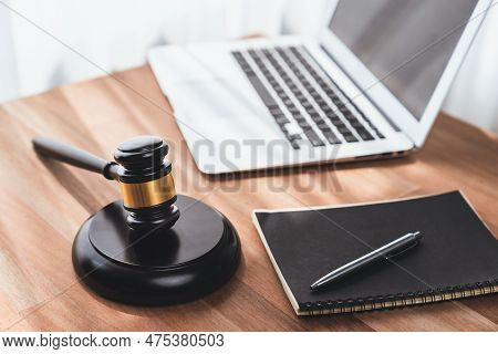 Closeup Wooden Gavel Hammer With Laptop And Book And Pen On Desk On Wooden Office Table Background A