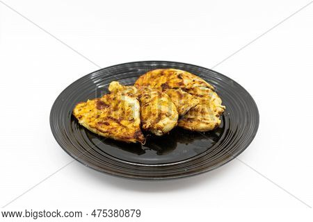Barbaqued Chicken Breast On A Black Plate