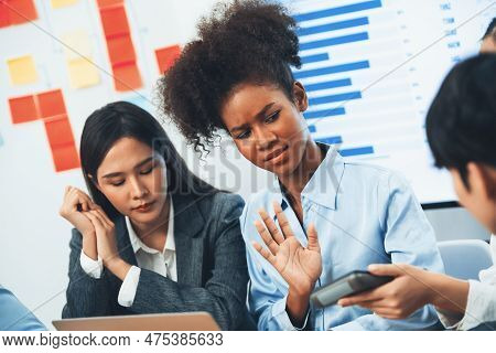Diverse Businesspeople Analyzing Financial Dashboard Data On Laptop In Serious Meeting, Confused And