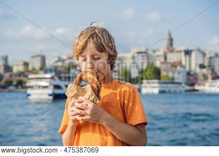 Boy In Istanbul Having Breakfast With Simit And A Glass Of Turkish Tea. Glass Of Turkish Tea And Bag