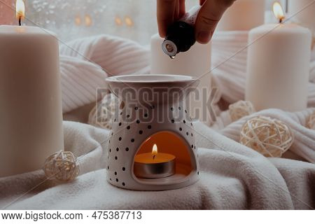 Aroma Lamp With Essential Oil, Aromatherapy At Home, Burning Candle, Dropping Essential Oil. Concept