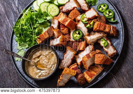 Lechon Kawali, Filipino Crispy Fried Pork Belly With Liver Sauce, Sliced Cucumber And Fresh Coriande
