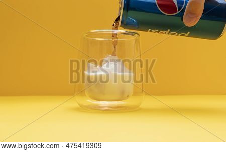 Someone Cook Pilk, Trendy Pepsi Milk Drink. Person Combining Soda And Dairy Beverages. Drinking Glas