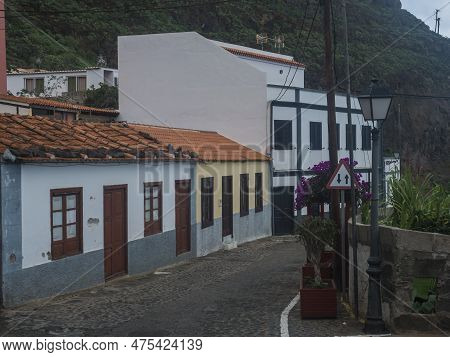 Cobbled Street With Colorful Traditional Houses In The Village Of Agulo Located In Green Valley At N