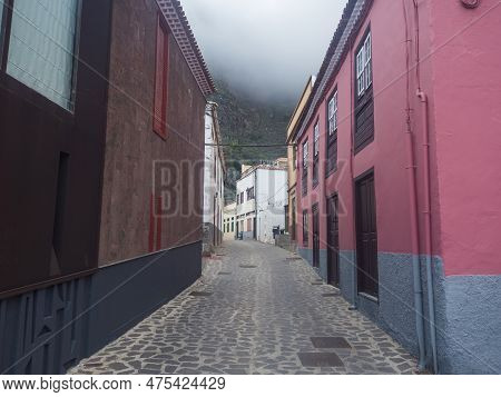 Cobbled Street With Colorful Traditional Houses In The Village Of Agulo Located In Green Valley At N