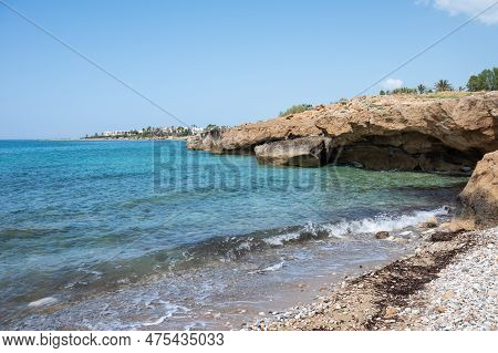 Sea Cave Rock Formation, Gravel Beach And Turquoise Water In Melanos, Cyprus