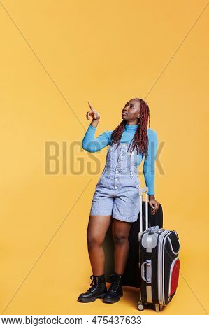 Traveller Pointing At Landmarks In Town, Having Fun On Holiday Trip With Trolley Bags. Young Woman S