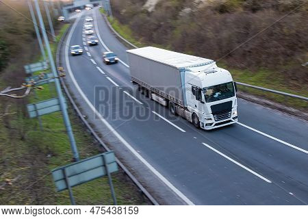 Road Transport. White Lorry Travelling On The Motorway.
