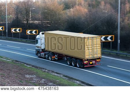Lorry Carrying Shipping Conteiner Travelling On The British Motorway.