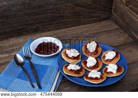 Pikelets/pancakes/battercakes With Strawberry Jam And Whipped Cream On A Blue Plate With Napkin, Spo