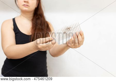 Unrecognizable Long Haired Ginger Woman In Black Top Hold Hairbrush With Hair In White Studio. Hair 