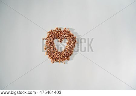 Buckwheat Grain Heart On White Background. Healthy Superfood Diet