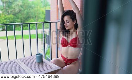 Somebody Keek On Young Pretty Brunett Woman In Red Bra And Panties Sitting On A Balcony Stretching A