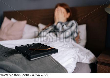 Close-up Selective Focus Shot Of Picture Frame On Blurred Backwound Of Crying Grief-stricken Young W