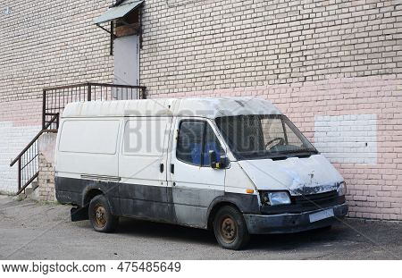 An Old Rusty White Minibus Is Parked Near A White Brick Wall, Antonova-ovseenko Street, St. Petersbu